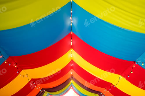 Preview: Cloths decorated with red and yellow colors hang from the ceiling as a colorful background.