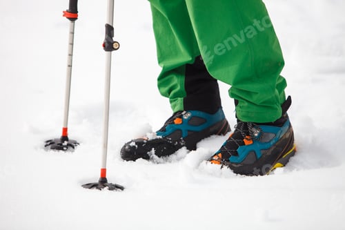Preview: Hiking boot closeup on mountain snow