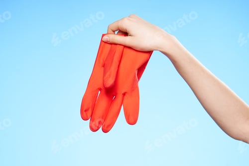 Preview: rubber glove in hand cleaning service blue background