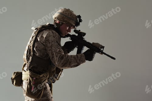 Preview: Soldier in tactical gear aims rifle during training at military facility