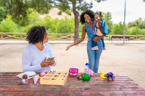 Preview: African woman and girl arriving at park with their grandmother