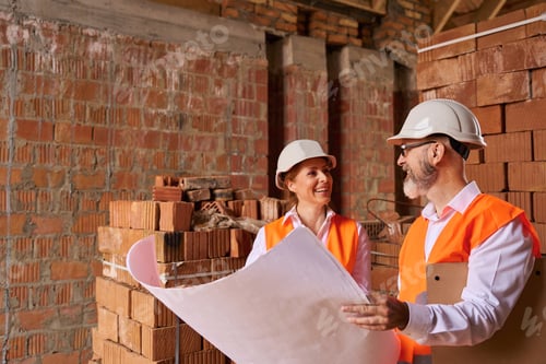 Preview: Contractor demonstrating architectural drawings to construction inspector