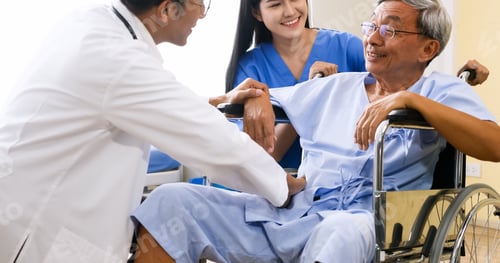Preview: Doctor and nurse taking care of adult patient at hospital room.