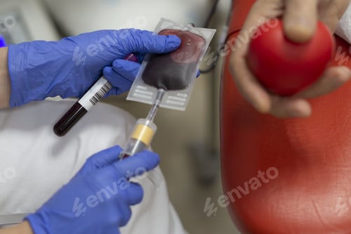 Preview: Selective focus shot of blood donator donating blood in the hospital