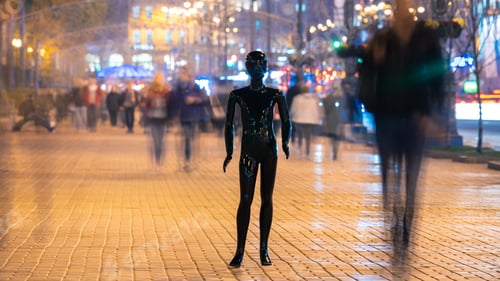 Preview: The black mannequin standing on the crowd street. evening time