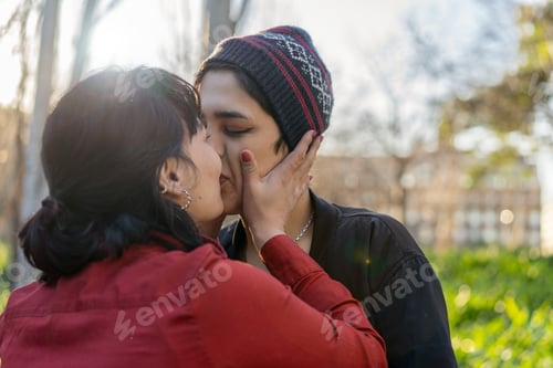 Preview: Young woman planting a sweet kiss on her girlfriend's lips