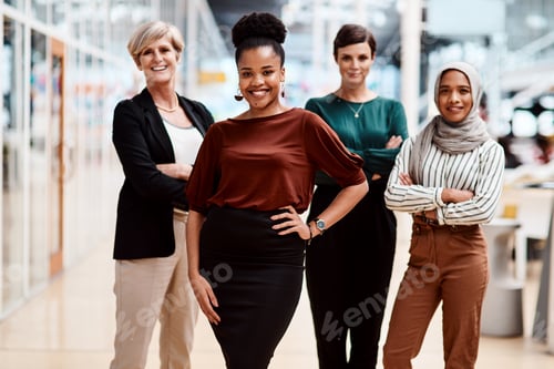 Preview: Portrait of a young businesswoman standing in an office with her colleagues in the background