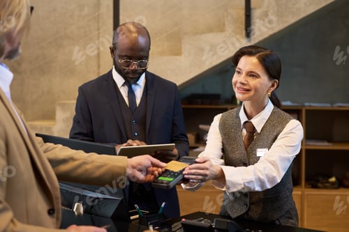 Preview: Concierge Processing Payment at Hotel Front Desk
