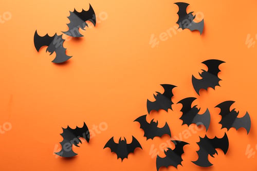 Preview: Halloween decor. Black paper bats on orange background, flat lay. Space for text