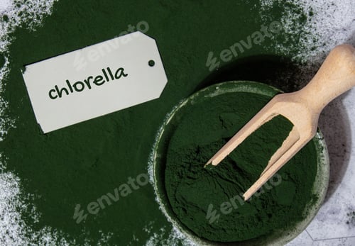 Preview: Blue-green algae Chlorella and spirulina powder in bowl with paper note text CHLORELLA. Super powder