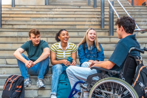 Preview: Diverse university students discussing and laughing on campus stairs