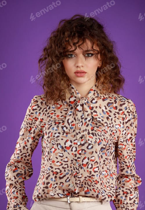 Preview: A vertical portrait of a curly-haired girl put her hands into her pocket and looked at the camera.