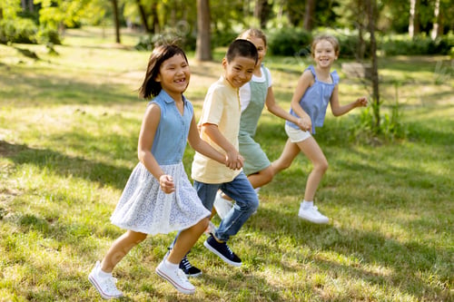 Preview: Group of asian and caucasian kids having fun in the park