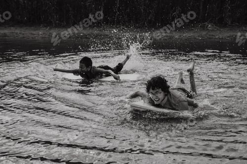 Preview: Happy boys swimming with board over water