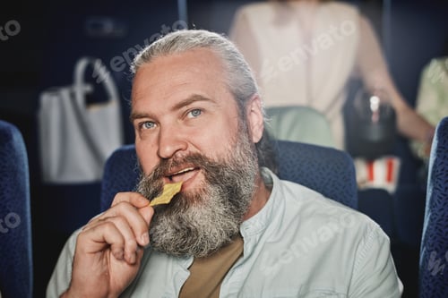 Preview: Man Having Snack At Cinema