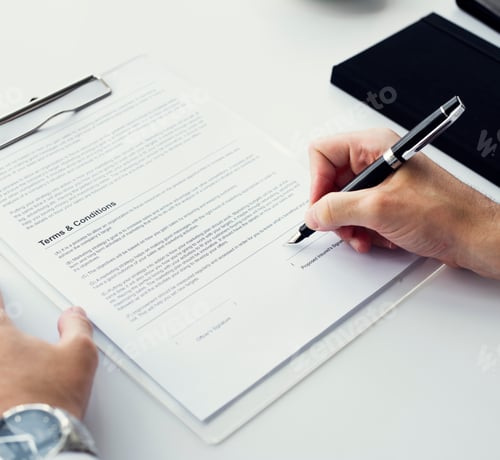 Preview: Closeup of hand signing paper workspace