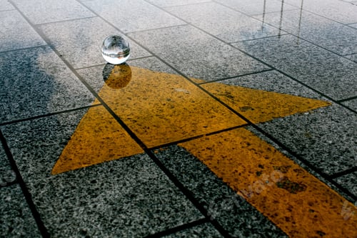 Preview: High angle shot of the stone ground with a yellow arrow pointing towards a mysterious crystal ball