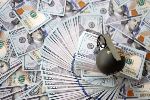 Preview: Grenade with a check against the background of huge amount of american dollar bills