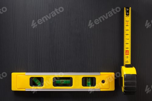 Preview: tape measure and level on wood