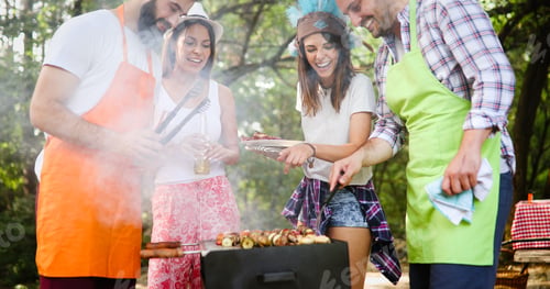 Preview: Friends having a barbecue party in nature