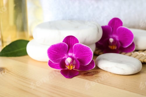 Preview: Spa stones and orchid flowers on wooden table