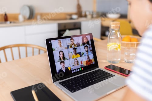 Preview: Back view of young woman talking with on video call with multiracial colleagues