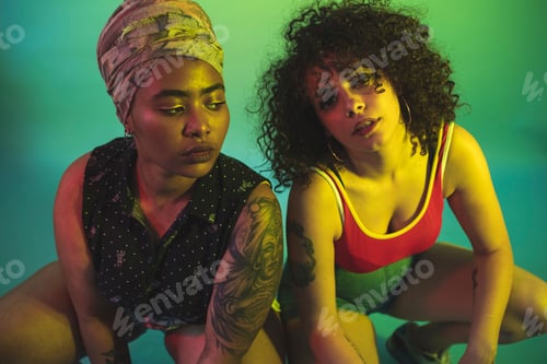 Preview: Two friends posing in colorful lighting