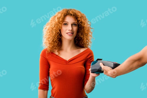 Preview: redhead woman paying with credit card on terminal, Isolated On blue