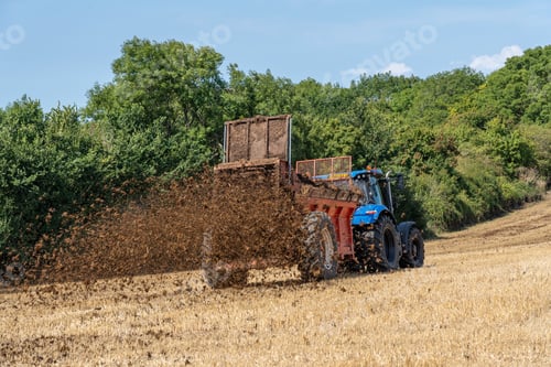 Preview: a tractor is driving through a grassy field