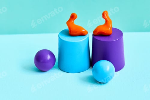 Preview: Colorful earplugs are creatively displayed on vibrant cylinder bases, hearing protection