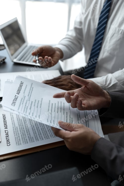 Preview: Businessmen or lawyers working together at a meeting, teamwork and partnership. Signing documents, c