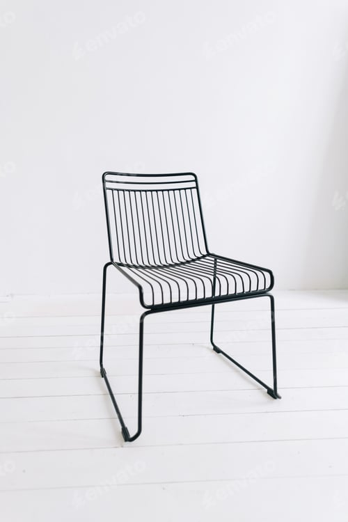Preview: Black metal modern chair in empty white room.