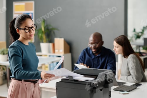 Preview: Asian Manager Printing Documents In Office