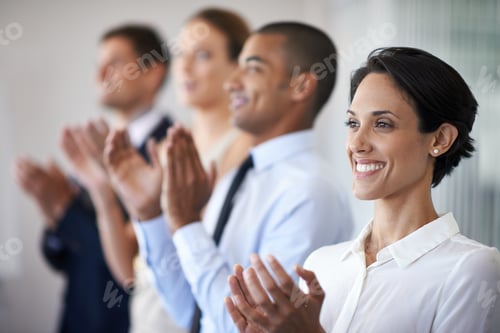 Preview: Thats something to celebrate. Shot of a row of smiling colleagues clapping.