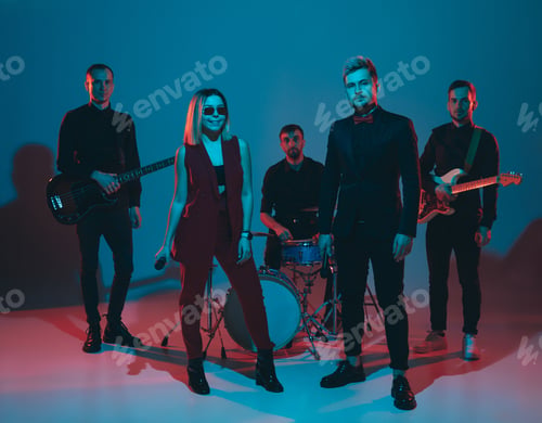 Preview: Young caucasian musicians, band performing in neon light on blue studio background