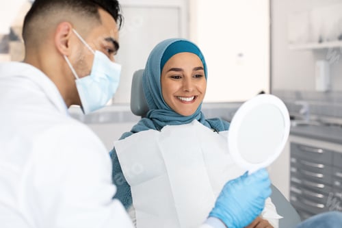 Preview: Muslim Lady In Hijab Looking At Her New Smile After Teeth Treatment