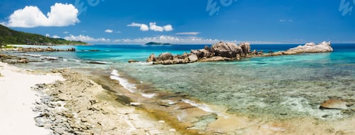 Preview: Old coral reef in the white sand beach on secluded beach of grand anse, La Digue, Seychelles. Aerial