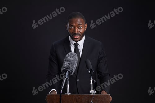 Preview: Confident African-American Speaker at Podium