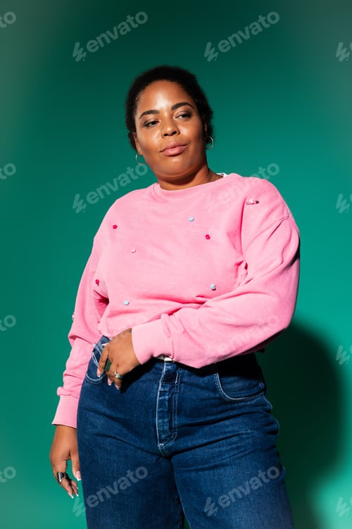 Preview: Stylish plus size woman showcases trendy autumn fashion in vibrant studio setting