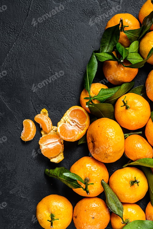 Preview: Tangerines, mandarines with leaves. Black background. Top view. Space for text