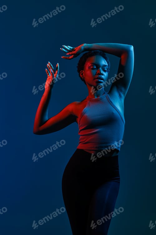 Preview: Woman moving gracefully over dark studio background
