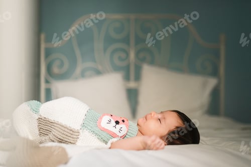 Preview: Cute baby sleeping on bed