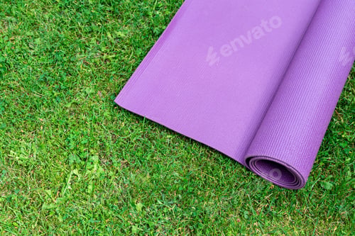 Preview: Fitness mat on the green grass background