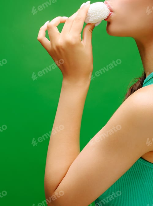 Preview: Enjoying a sweet treat against a vibrant green backdrop for a fun day