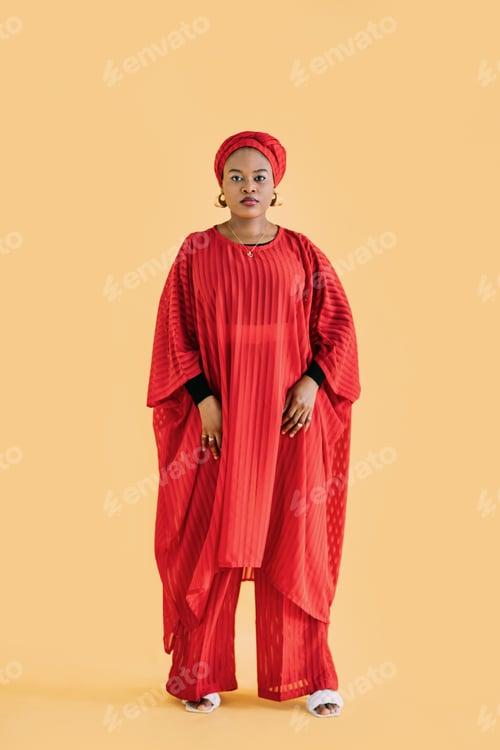 Preview: Full length portrait of pretty African woman wearing red fashionable red suit and head wrap scarf
