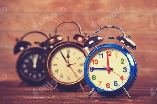 Preview: Retro alarm clocks on a table.