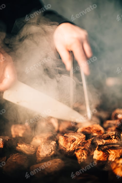 Preview: Man grilling food on a barbecue in a backyard setting