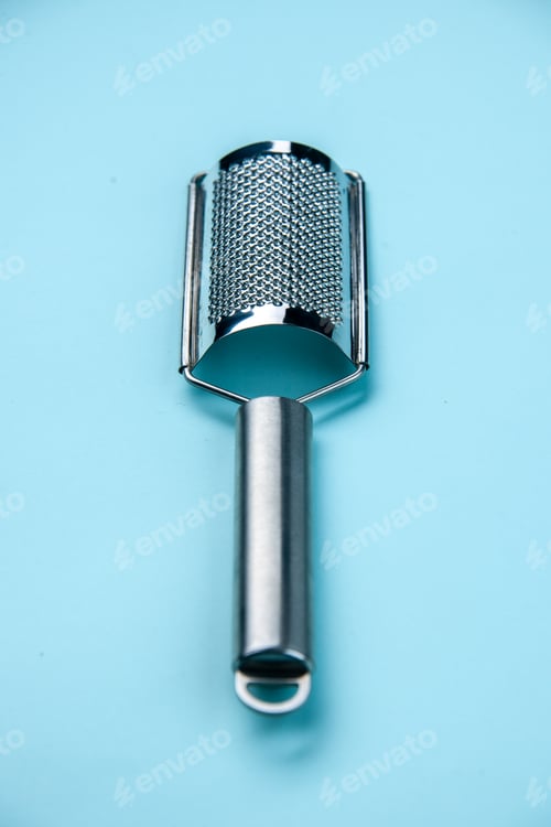 Preview: Front close view of stainless kitchen tool on pastel blue background with free space