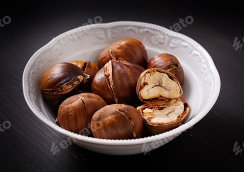 Preview: Roasted chestnuts on dark wooden background