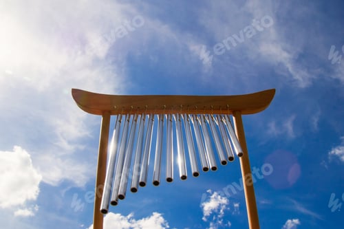 Preview: Wind musical chimes on the background of blue summer sky.